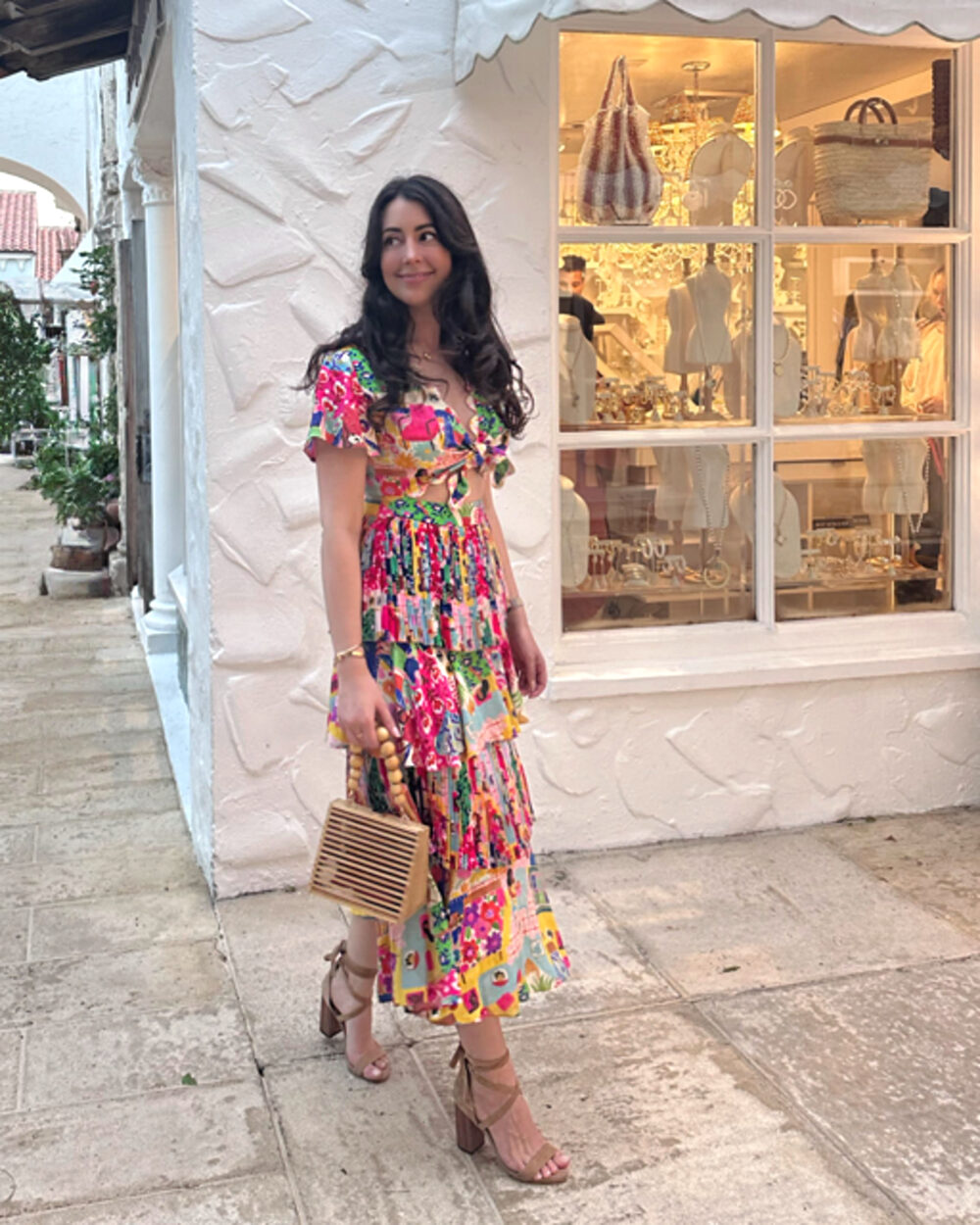 Emma Werner wearing a colorful floral dress outside a boutique